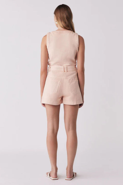 Woman wears a pink coral short