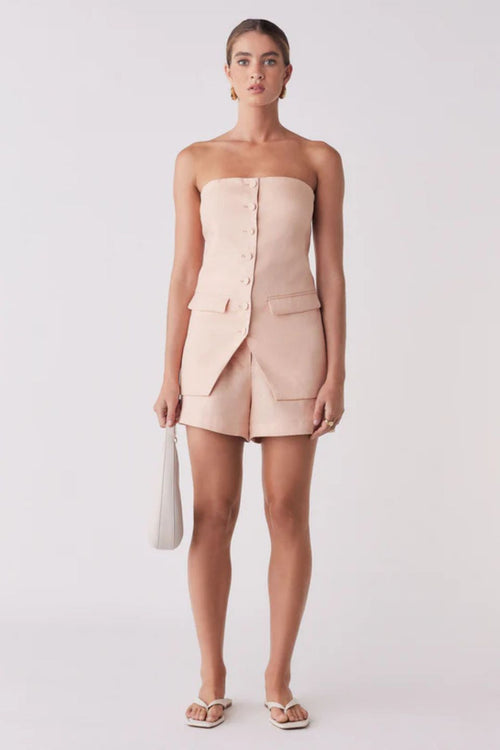 Woman wearing a pink sleeveless button down vest