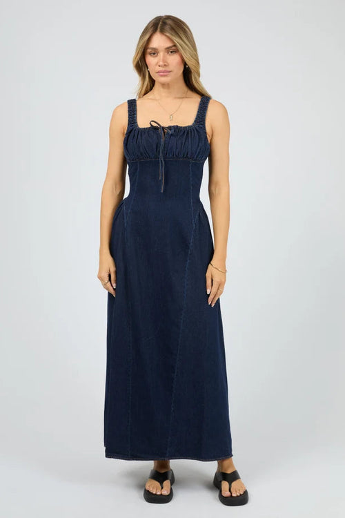 Woman wearing a navy blue dress on a white background