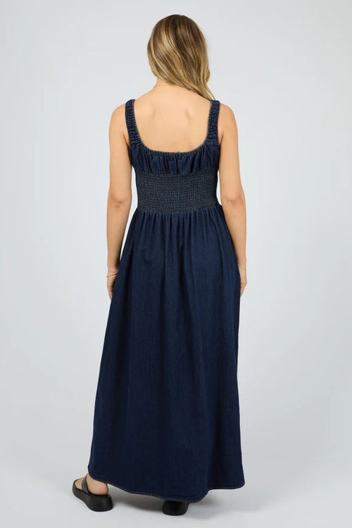 Woman wearing a navy blue dress on a white background