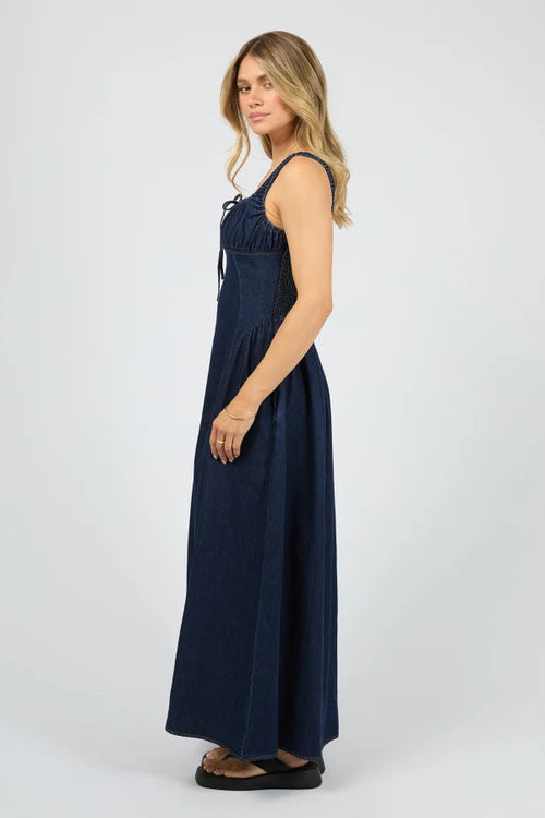 Woman wearing a navy blue dress on a white background