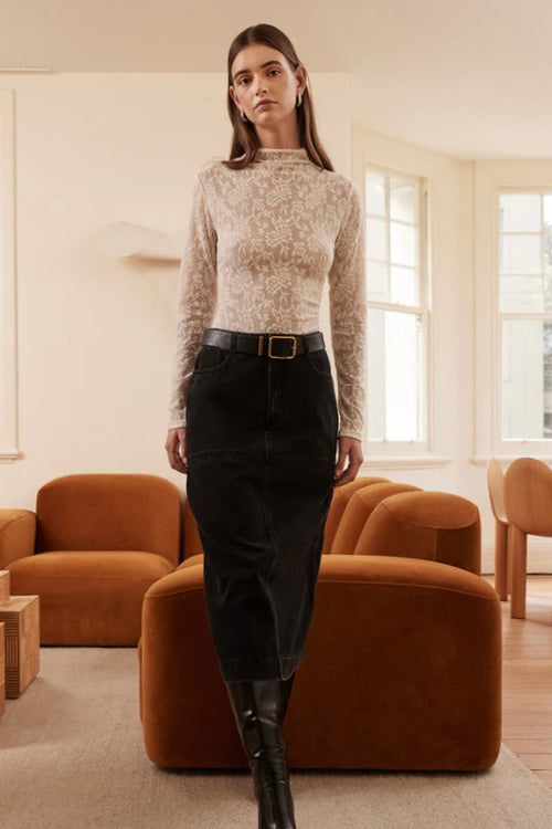 Model wears a cream lace long sleeve high neck top