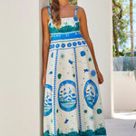 Woman wears a colourful blue strappy maxi dress