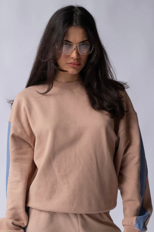 model wears brown with blue stripe sweatshirt