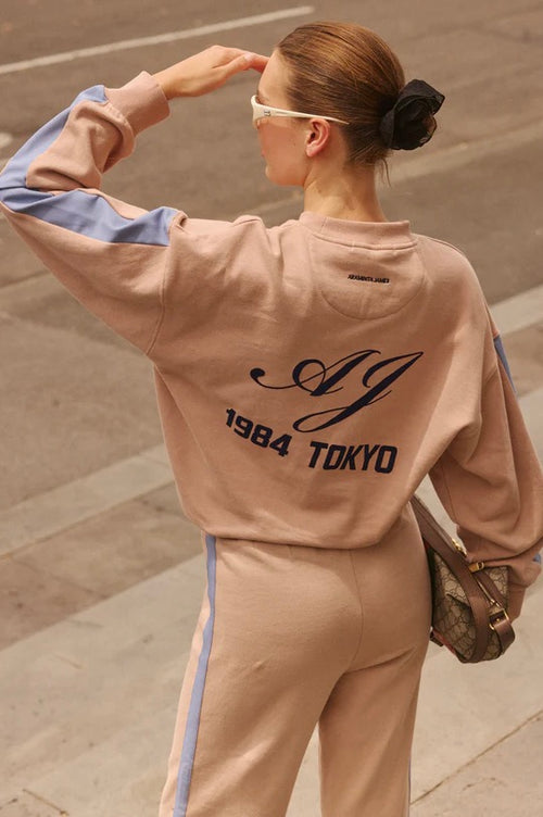 model wears brown with blue stripe sweatshirt