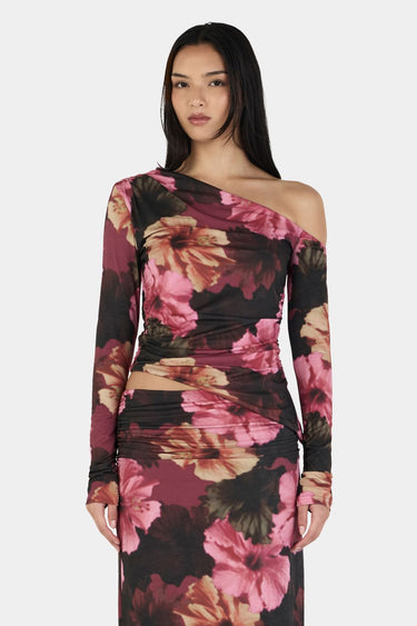 Woman wearing a floral one-shoulder dress on a white background