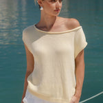 Woman wearing butter yellow knit top