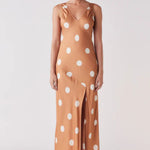 Woman wearing a brown and white spot dress 