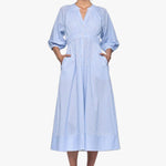 woman wearing a blue and white striped midi shirt dress