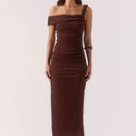 Woman wearing a brown off-shoulder dress on a white background