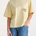 Woman wearing a yellow graphic tee and blue jeans 