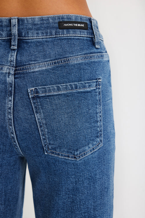Blue jeans with a brand label on a white background