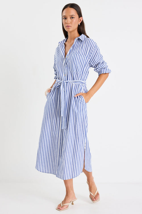 Woman wearing a blue and white striped dress on a white background