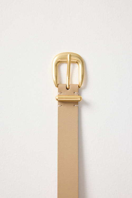 Beige belt with a gold buckle on a light gray background