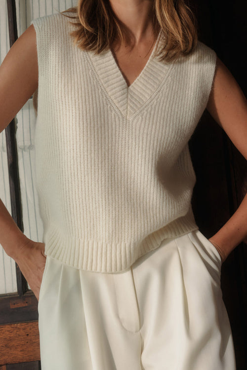 Model wears a white knit vest