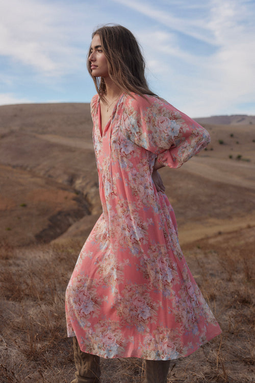 model wears a pink floral midi dress