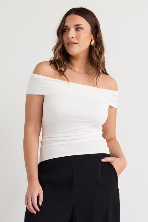 model wears a white off the shoulder top