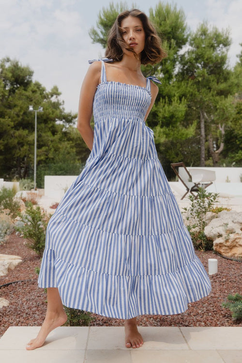 Woman wears a blue white stripe dress