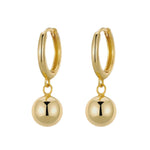 Gold hoop earrings with round dangling beads on a white background