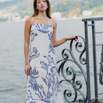 model wears a white and blue floral midi dress