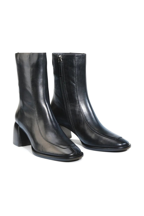 Pair of black leather ankle boots on a white background