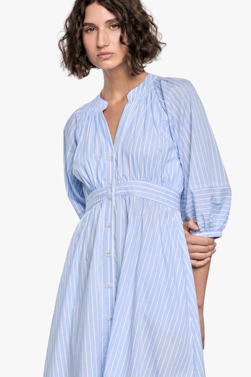 woman wearing a blue and white striped midi shirt dress