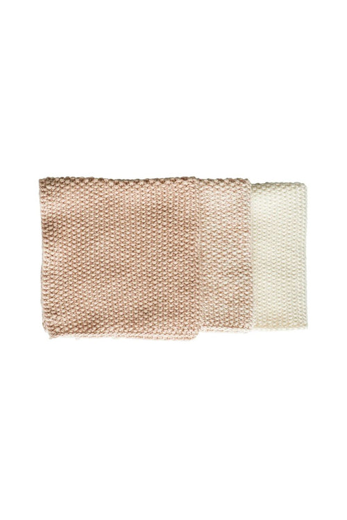 Two square woven fabric napkins or cloths in a textured basketweave pattern, shown overlapping on a plain white background. One is a warm beige/taupe and the other is off-white/cream.