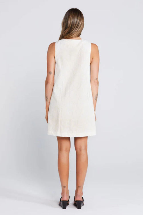 Woman wearing a light floral button down mini dress