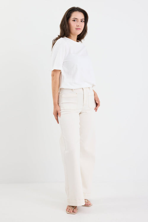 Woman wearing a white t-shirt and pants on a white background
