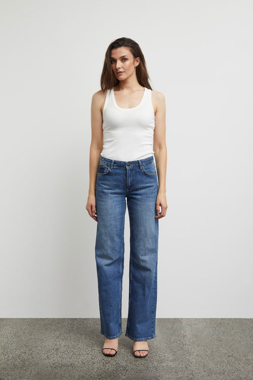 Model wears vega medium blue high rise jean