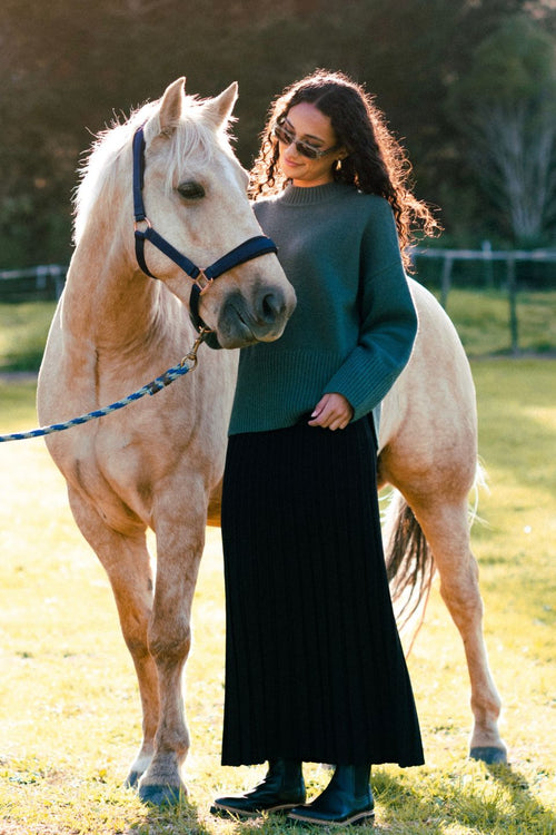 model wears a black knit maxi skirt