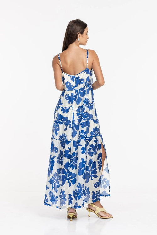 Woman wearing a blue floral dress on a white background