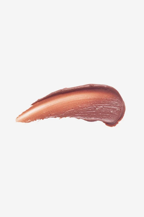 A textured swipe of a warm, creamy coppery-brown cosmetic lipstick on a solid white background.