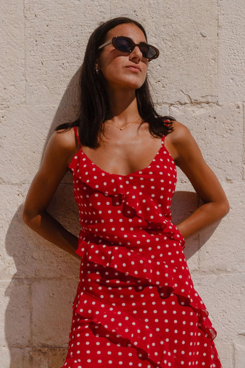 Woman wearing a mini red white polka dot ruffle dress