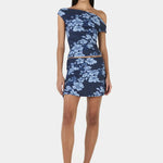 Woman wears a navy blue floral top and skirt