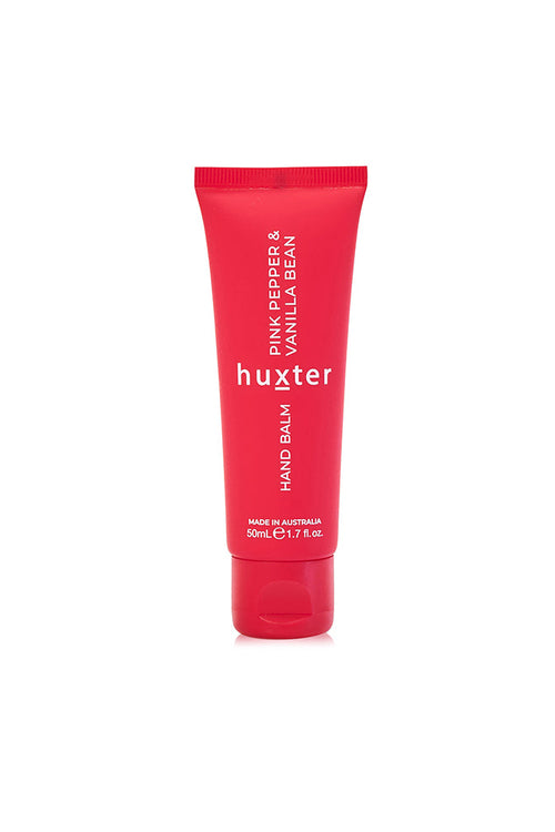A red squeeze tube of Huxter Hand Balm, Pink Pepper & Vanilla Bean, centered on a plain white background.