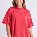Woman wearing a red oversized tee