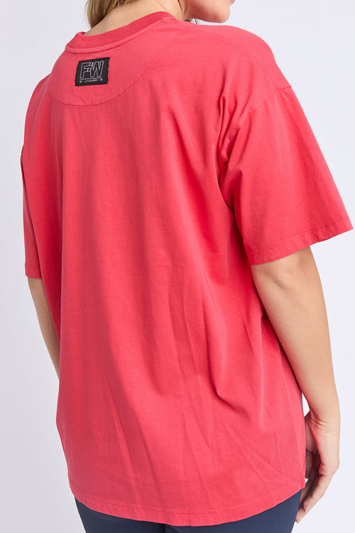 Woman wearing a red oversized tee