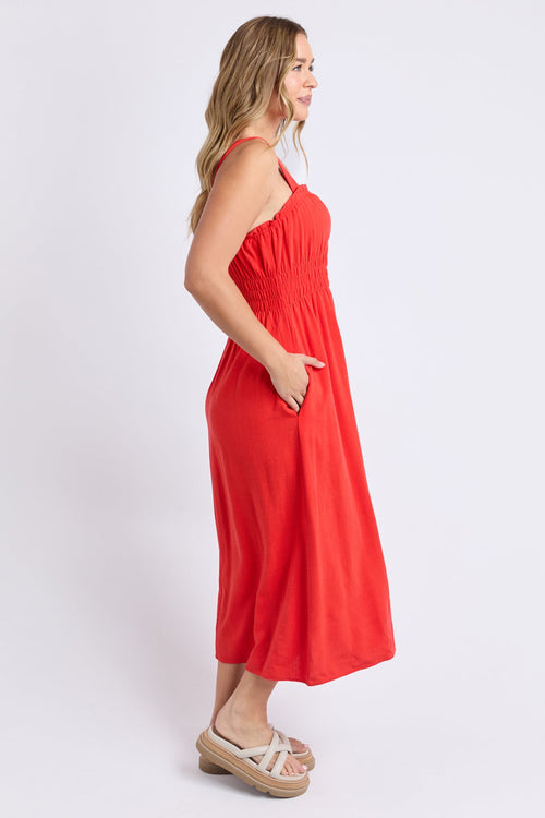 Woman wears a orange red maxi dress
