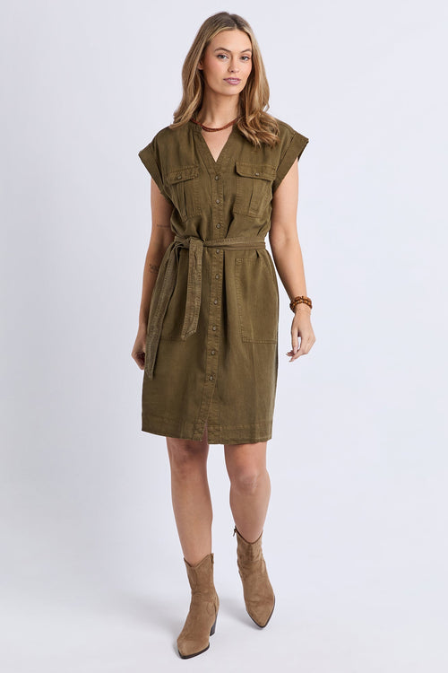 Woman wearing a green dress with a belt on a white background