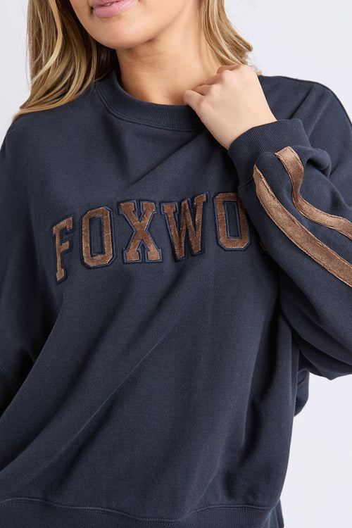 Navy sweatshirt with 'FOXWOOD' branding on a white background