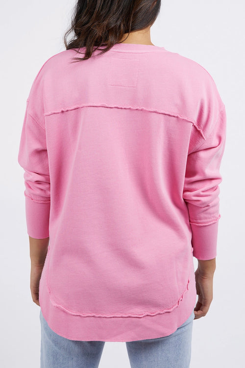 model wears a pink jumper