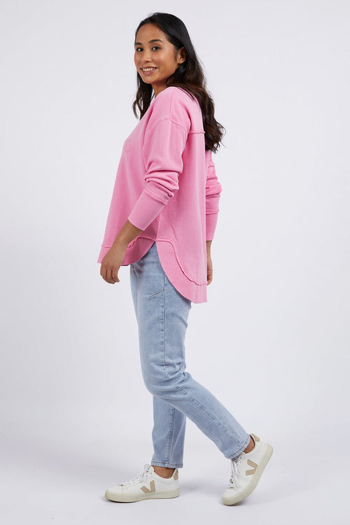 model wears a pink jumper