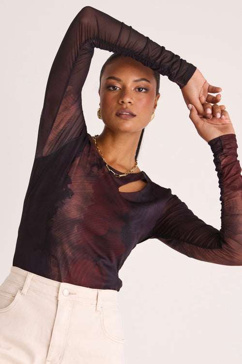 model wears a long sleeve brown top