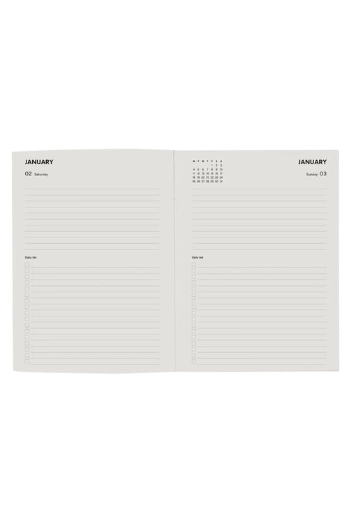 An open planner or notebook showing two blank lined pages for January, with a small calendar grid at the top of each page, photographed on a plain white background.