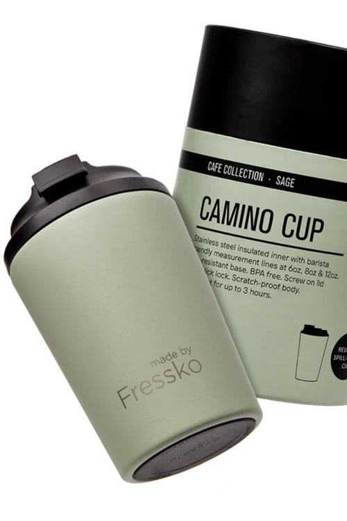 Green tumbler with black lid and packaging labeled 'Camino Cup' on a white background