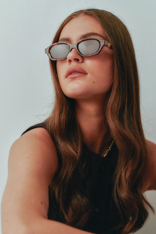 model wears brown tort sunglass