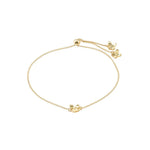 Gold bracelet with a small decorative element on a white background