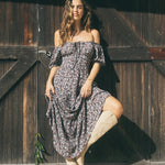 Woman wearing a dark purple floral maxi dress