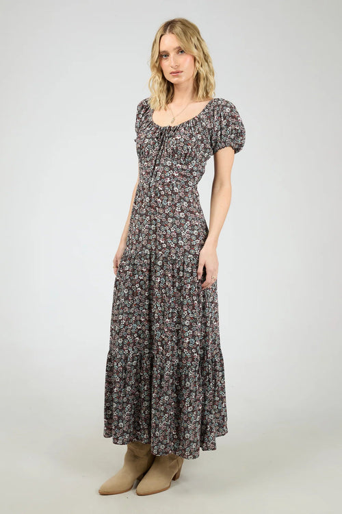 Woman wearing a dark purple floral maxi dress